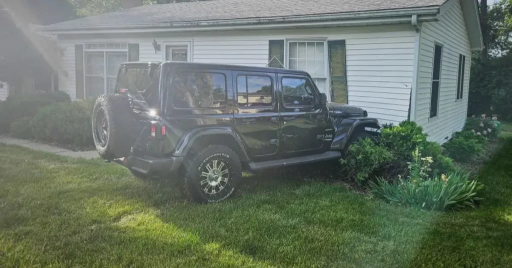 Black Jeep Slams Into Illinois Home
